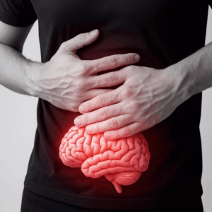 Persona sosteniendo su abdomen con un cerebro brillante visible bajo las manos, representando la conexión entre la depresión y la microbiota intestinal.